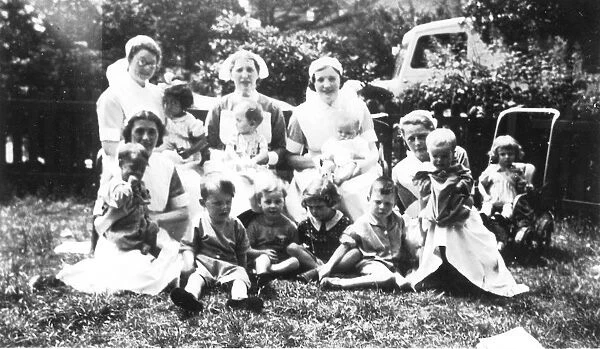 Informal outdoor group of nurses and children