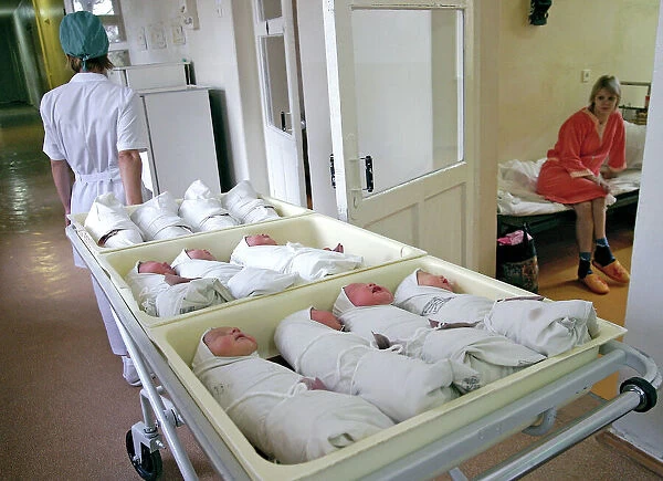 Newborn baby being weighed in a hospital available as Framed Prints,  Photos, Wall Art and Photo Gifts