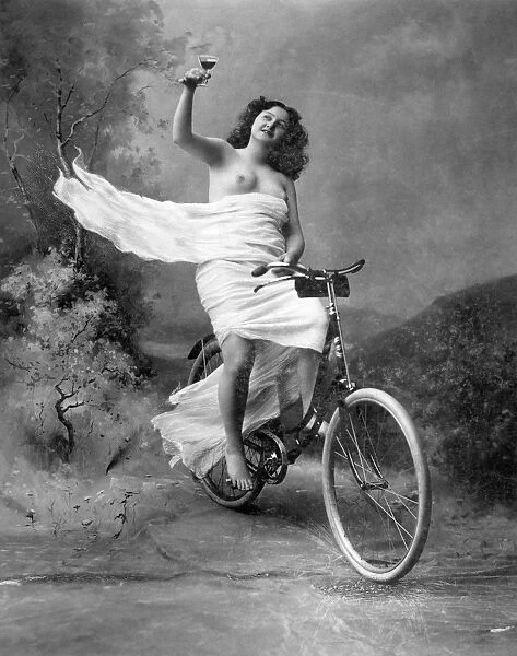 ONE FOR THE ROAD, c1900. Nude on a bicycle