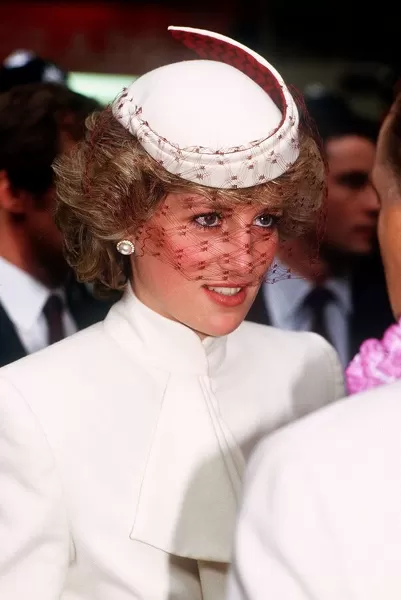 Princess Diana, wearing a white ensemble with red accents