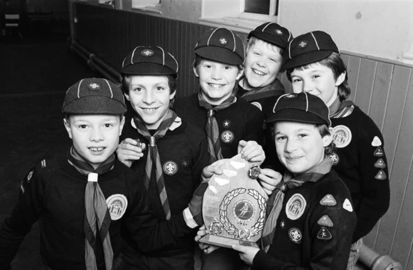 Showing off the shield they won in a five-a-side football competition are these members