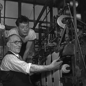 A handframe knitter seen here with his apprentice at The Shawl Factory of GH Hurt