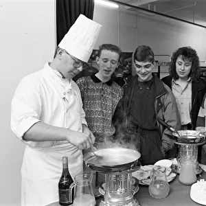 Second year student Simon Taylor makes flamb? pancakes in brandy for school pupils