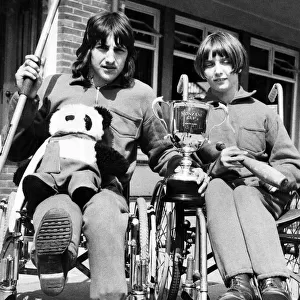 Two wheelchair champions from the Percy Hedley School in Newcastle show off the cup which