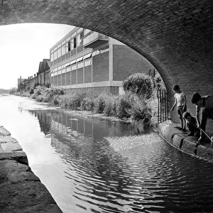 These young lads are having fun fishing with a net in the Coventry Canal at the Cash