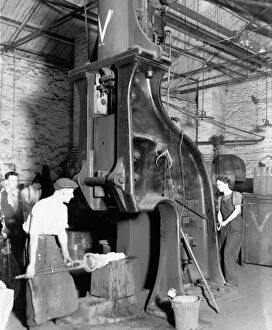 1942 Collection: A man and woman carrying out work on a steam hammer during WW2, 1942