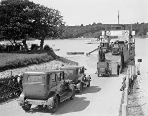 Railway Posters Poster Print Collection: Cars and motorcycles arriving on board the ferry at Fishbourne, 1932