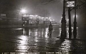Pedestrian Collection: The Embankment, London on wet night with Policeman and Trams
