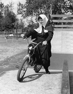 Unexpected Collection: Nun on a bicycle in a playground