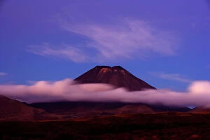 Abstract art Fine Art Print Collection: Mount Ngauruhoe peak of perfectly shaped volcanoe Mt Ngauruhoe sticking out of clouds at dusk