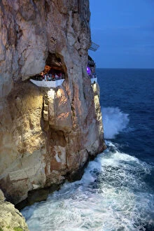 Holidays Collection: Bar built in cliff caves, Cova d en Xoroi in evening, Cala en Porter, Menorca, Balearic Islands