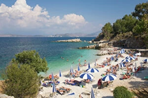 Greek Islands Collection: Beach crowded with holidaymakers, Kassiopi, Corfu, Ionian Islands, Greek Islands, Greece, Europe