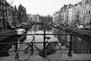 Amsterdam Poster Print Collection: Black and white imge of an old bicycle by the Singel canal, Amsterdam, Netherlands