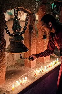 Serene People Collection: A Buddhist monk rings a prayer bell during the full moon celebrations, Bodhnath stupa, Bodhnath