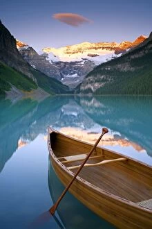 Canadian Rockies Pillow Collection: Canoe on Lake Louise at Sunrise, Lake Louise, Banff National Park, Alberta, Canada