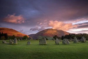 Heritage festivals and traditions Collection: Castlerigg Stone Circle in autumn at sunrise with Blencathra bathed in dramatic dawn light