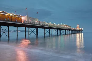 Torbay Collection: A dusk view of a classic seaside pier, Paignton Pier, Torbay, Devon, England