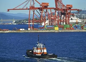 Vancouver Collection: Harbour tug with containers and cranes in the background, in Vancouver