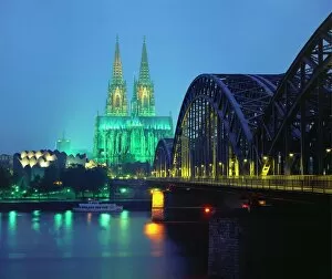 Riverbank Collection: Hohenzollernbrucke and the Cathedral Illuminated at Night, Cologne, Germany