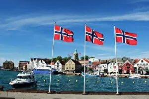 Related Images Jigsaw Puzzle Collection: Norwegian flags and historic harbour warehouses, Stavanger, Norway, Scandinavia, Europe