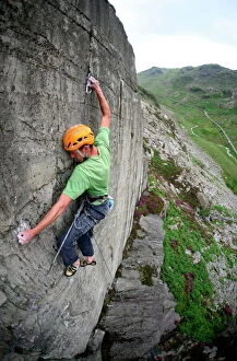Related Images Framed Print Collection: A rock climber makes a first ascent of on the cliffs above the Llanberis Pass