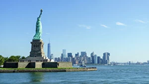 Urban cityscapes Poster Print Collection: Statue of Liberty and Liberty Island with Manhattan skyline in view, New York City, New York