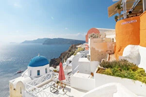 Greek Islands Collection: View of blue domed church from cafe in Oia village, Santorini, Aegean Island, Cyclades Island