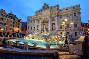 International Landmark Collection: View of Trevi Fountain illuminated by street lamps and the lights of dusk, Rome, Lazio