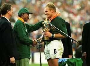 Rugby World Cup Photo Mug Collection: Francois Pienaar receives the Webb Ellis Cup from Nelson Mandela