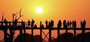 Burma Collection: Silhouettes on the U Bein Bridge at sunset, Amarapura, Myanmar