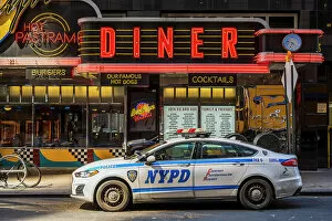 Related Images Poster Print Collection: Diner restaurant neon sign with NYPD police car parked, Manhattan, New York, USA