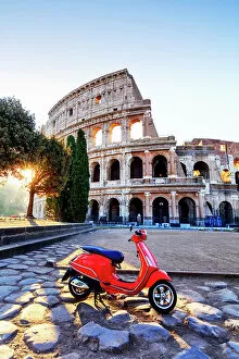 Colosseum Collection: Italy, Rome, a red Vespa motorbike in front of Colosseum at sunrise