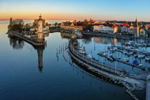 Related Images Jigsaw Puzzle Collection: Lindau harbour with Mangturm Tower and Lighthouse at Sunrise, Lake Constance, Swabia, Bavaria