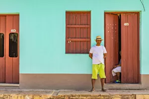 Cobblestones Collection: A man standing outside his house in a street in Trinidad, Sancti Spiritus, Cuba