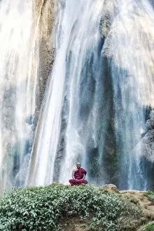 Monks Collection: Myanmar, Mandalay division, Pyin Oo Lwin. Burmese monk meditating under Dattawgyaik Waterfall