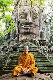 Monks Collection: Southeast Asia, Cambodia, Siem Reap, Angkor temples, Buddhist monk in saffron robes meditating