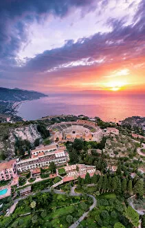 Greece Greetings Card Collection: Taormina, Sicily. Aerial view of the Greek theater with the sun rising on the sea in the