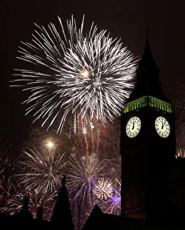 Big Ben Mouse Mat Collection: Fireworks explode behind the Big Ben clock tower during New Year celebrations in London