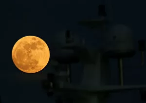 Malta Cushion Collection: A supermoon full moon rises behind the antennae domes on a motor yacht in Pieta