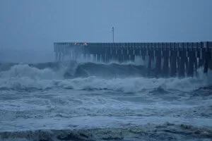 Panama City Collection: Waves crash along a pier as Hurricane Michael approaches Panama City Beach