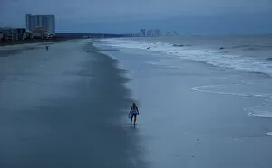 Walk Leisure Collection: A woman looks for shells ahead of the arrival of Hurricane Florence in Surfside Beach