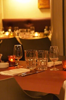 Cuisine Collection: Interior of The restaurant Brunel at night. Tables with glasses, knives, ofrks, glasses
