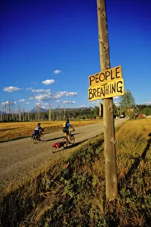 Model Release Collection: Mountain bikers head into Polebridge while riding on the Great Divide Route in Montana