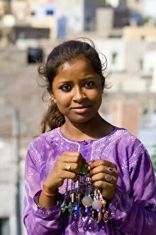 26 Sep 2014 Fine Art Print Collection: Young Indian girl aged 15 in purple in front of village of Jodhpur in Rajasthan India