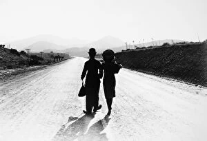 Action Collection: CHAPLIN: MODERN TIMES, 1936. Charlie Chaplin and Paulette Goddard in the final scene from