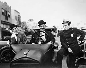 Film Jigsaw Puzzle Collection: LAUREL AND HARDY, 1928. Stan Laurel, left, and Oliver Hardy with a police officer in the silent
