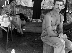 Lumberjack Collection: An unemployed lumberjack with his wife in a migrant workers camp for the bean harvest