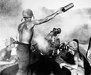 Sight Collection: VIETNAM WAR: ARTILLERY. An American artilleryman discards a spent shell casing