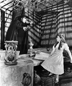 Movie Star Collection: WIZARD OF OZ, 1939. Margaret Hamilton as the Wicked Witch of the West and Judy Garland as Dorothy