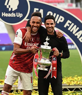 Posters Collection: Arsenal's Mikel Arteta and Pierre-Emerick Aubameyang Lift FA Cup after Empty-Stadium Victory over